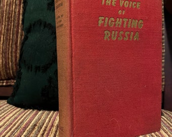 May include: A red hardcover book with gold lettering on the spine and front cover. The title of the book is "The Voice of Fighting Russia".