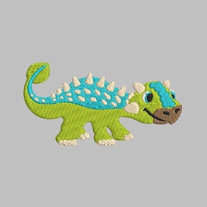 May include: Green and blue embroidered cartoon dinosaur with white spikes on its back.
