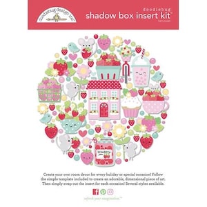 May include: A shadow box insert kit with a strawberry theme. The design includes strawberries, flowers, a house, a teacup, a milkshake, and mice. The text on the top reads "shadow box insert kit".