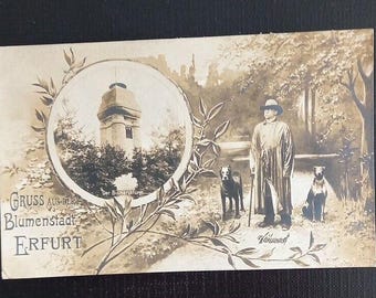 May include: A vintage postcard with a sepia tone image of a tower in a park. The postcard says "Gruss aus der Blumenstadt Erfurt" which translates to "Greetings from the Flower City Erfurt".