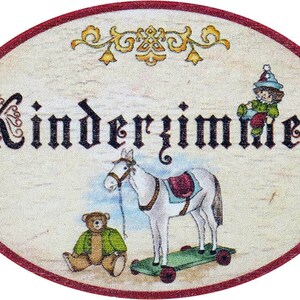 May include: A vintage-style oval sign with the text "Kinderzimmer" in black script. The sign features a white horse on a skateboard, a teddy bear, and a clown figure.