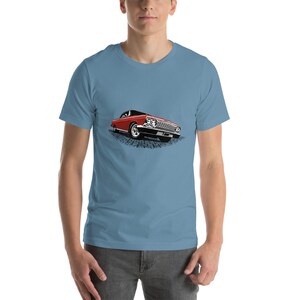 May include: A blue t-shirt with a red vintage car graphic. The car is a classic American muscle car with a chrome bumper and whitewall tires.