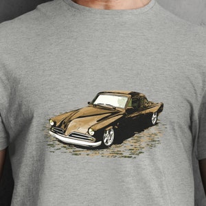 May include: A brown vintage car with a chrome bumper and whitewall tires. The car is on a gray background.