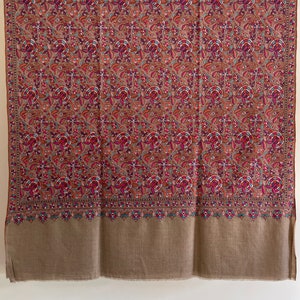 May include: A brown shawl with a floral pattern in shades of pink, red, blue, and green. The shawl has a solid brown border.