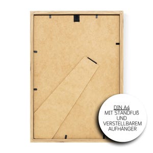 May include: The back of a wooden picture frame with a brown cardboard backing. The frame is designed to hold a DIN A4 size print. The frame has a stand and an adjustable hanger.