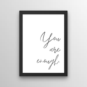 Könnte beinhalten: Schwarz gerahmter Druck mit dem Text "You are enough." in weißer Kursivschrift.