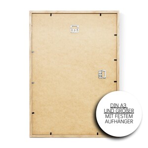 May include: A wooden picture frame with a light brown finish. The frame is designed for a DIN A3 size print and has a sturdy hanger.
