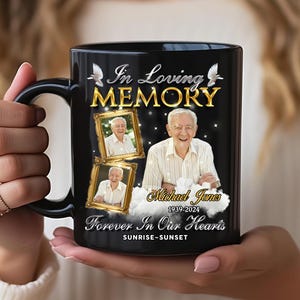 May include: Black ceramic mug with the words "In Loving Memory" in gold lettering, featuring photos of a man and the text "Michael Jones 1939-2024". The mug also has the words "Forever In Our Hearts" and "Sunrise-Sunset".