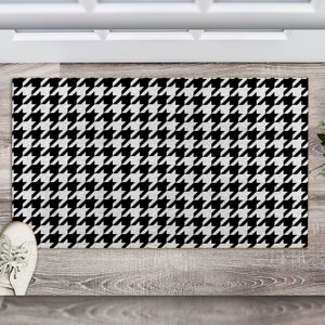 May include: Black and white patterned doormat with a houndstooth design.