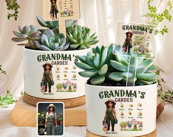 May include: Two white ceramic planters with succulents, each featuring a "Grandma's Garden" design. The planters have a wooden base and include a personalized illustration and name. One planter has a wooden sign.
