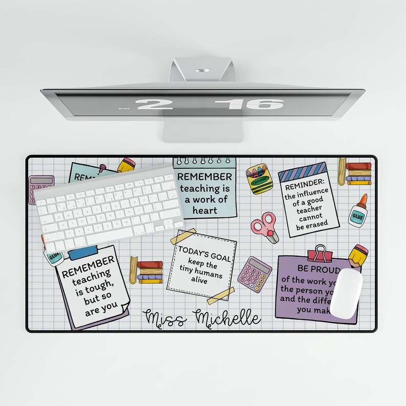 May include: A colorful desk mat with a grid pattern and inspirational quotes for teachers. The quotes include "Remember teaching is a work of heart", "Today's Goal: Keep the tiny humans alive", "Reminder: The influence of a good teacher cannot be erased", and "Be proud of the work you do, the person you are, and the difference you make". The mat also features a calculator, scissors, crayons, glue, and books.