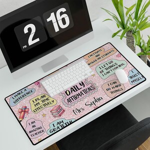 May include: Pink and white desk mat with inspirational quotes and a keyboard. The quotes include "I make a difference", "I plan my time effectively", "Daily affirmations", "I motivate and empower my students", "I let go of things I can't control", "I can do hard things", and "I trust myself".