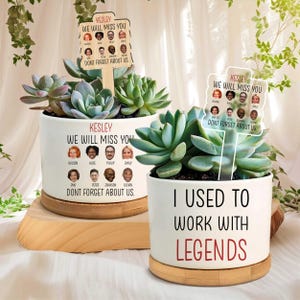 May include: Two white ceramic planters with succulents. One planter reads "KESLEY WE WILL MISS YOU DON'T FORGET ABOUT US" with employee photos. The other reads "I USED TO WORK WITH LEGENDS". Both sit on wooden saucers.