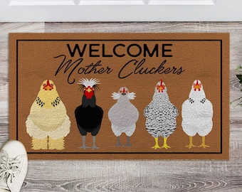 May include: Welcome Mother Cluckers doormat with a brown background and five chickens in a row. The chickens are a black rooster, a white rooster, a gray rooster, a white rooster with black spots, and a white rooster with black spots.