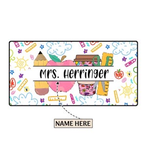 May include: A white background with a colorful pattern of school supplies, including a pencil, apple, coffee cup, scissors, and ruler. The text "Mrs. Herringer" is written in black on a white banner.