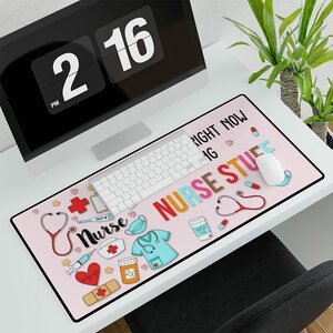 May include: Pink mouse pad with a colorful design featuring a stethoscope, a syringe, a pill bottle, a cup of coffee, and the text "Nurse Stuff Right Now".