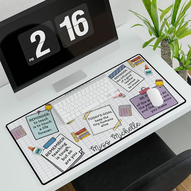 May include: A white desk mat with a grid pattern and colorful illustrations of school supplies. The text "Miss Michelle" is written in a pink script font. The text "REMINDER: to teach is to touch a life forever." is written in a black and white box. The text "TODAY'S GOAL: keep the tiny humans alive" is written in a black and white box. The text "REMINDER: the influence of a good teacher cannot be erased" is written in a black and white box. The text "BE PART of the world, the people and the difference you make" is written in a black and white box.