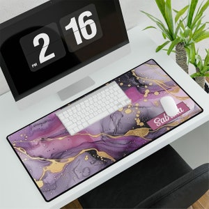 May include: A purple and gold marble desk mat with a pink name tag that says "Sabrina".