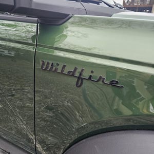 May include: A rustic wooden sign with the text "Welcome to our home" in white lettering. The sign features a distressed finish and a simple, inviting design, perfect for entryway decor.