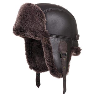 May include: A brown leather and shearling aviator hat with ear flaps and a buckle strap.