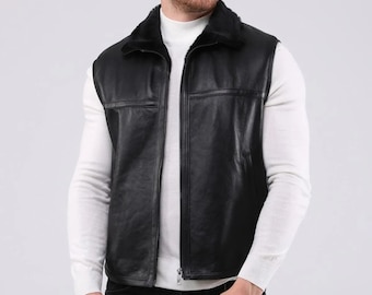 May include: A black leather vest with a fur collar and a zipper closure.