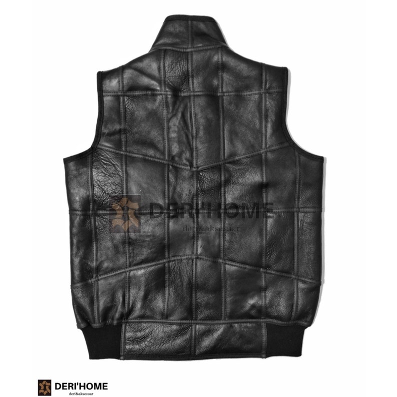 May include: Black leather vest with a quilted design and a stand-up collar. The vest has a ribbed knit bottom band.