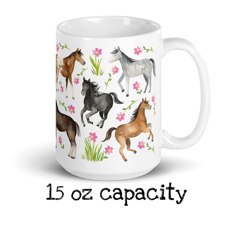 May include: White ceramic mug with a 15 oz capacity featuring a watercolor design of horses and pink flowers.