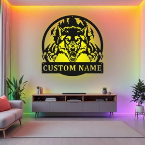 May include: Black metal wall art featuring a wolf's head emerging from a circular frame. The wolf's head is outlined in yellow and the text "CUSTOM NAME" is below the frame.