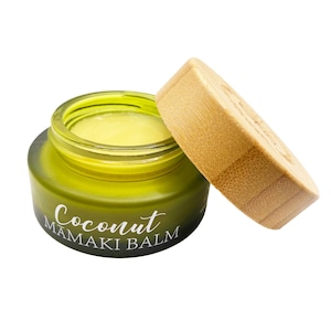 May include: A green glass jar with a bamboo lid, filled with a yellow balm. The jar has the text "Coconut Mamaki Balm" printed on the front.