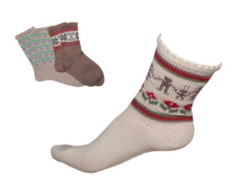 May include: Three pairs of socks with different patterns. One pair is brown with a white and red geometric pattern, one pair is beige with a purple and green floral pattern, and one pair is white with a red, green, and brown geometric pattern.
