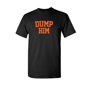 May include: Black t-shirt with the text "DUMP HIM" in orange letters.
