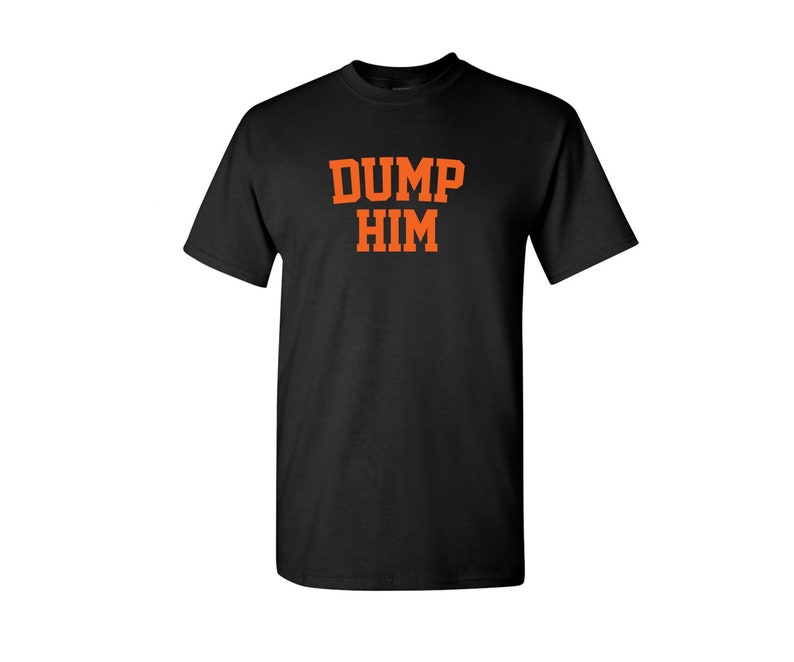 May include: Black t-shirt with the text "DUMP HIM" in orange letters.