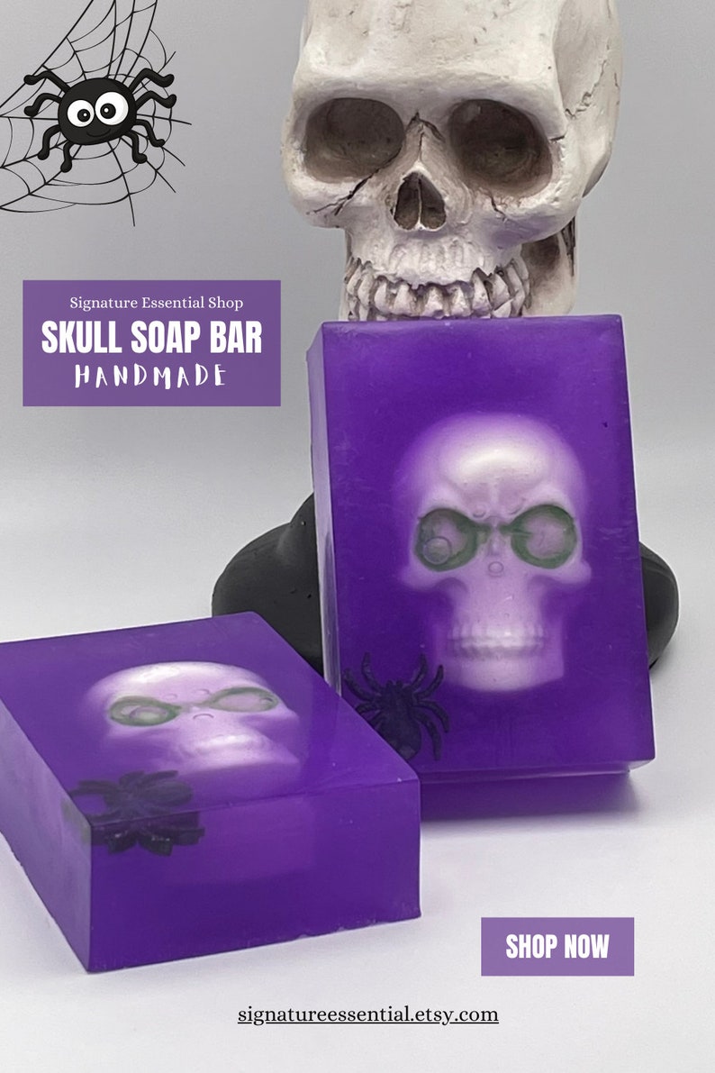 May include: Two purple soap bars with a white skull design and a black spider. The soap bars are handmade and have the text "Skull Soap Bar Handmade" on the front.