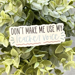 May include: A white sticker with the text "Don't make me use my teacher voice" in black lettering. The sticker has a wavy border and a red and white striped border.