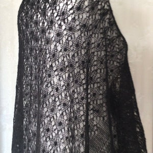 Puede incluir: Chale de encaje negro con un delicado patr&oacute;n de peque&ntilde;os c&iacute;rculos. El chal est&aacute; drapeado sobre un maniqu&iacute;.