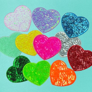 May include: Assortment of ten heart-shaped sequin patches in various colors, including pink, green, blue, yellow, orange, red, white, and purple.