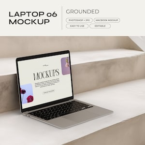 May include: A silver laptop computer with a black screen displaying a website with the word "Mockups" in white text. The laptop is sitting on a white concrete step with a white railing in the background.