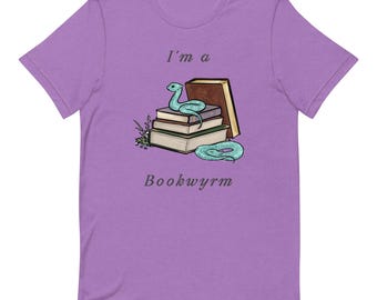 May include: Purple t-shirt with a light blue snake curled around a stack of books. The text "I'm a Bookwyrm" is printed on the shirt.