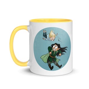 May include: A white ceramic mug with a yellow rim features a cartoon illustration of two characters. One character is falling from the sky, while the other character is looking up in surprise. The background is a light blue circle with a white outline.