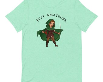 May include: A green t-shirt with a cartoon image of a female archer wearing a green hooded cloak and holding a bow and arrow. The text "PFFT. AMATEURS." is printed on the shirt.