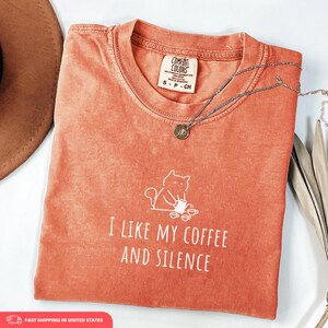 May include: A set of three ceramic mugs with a speckled, matte finish. The mugs are in shades of cream, light gray, and dark gray. Each mug has a simple, minimalist design, perfect for coffee or tea.