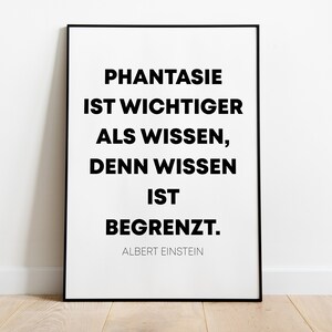 Op de afbeelding: Zwart-wit ingelijste print met een citaat van Albert Einstein: "Fantasie ist wichtiger als Wissen, denn Wissen ist begrenzt."