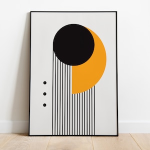 May include: A framed abstract print with a black circle, a yellow crescent shape, and black vertical lines on a white background.