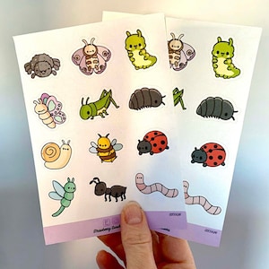 May include: Two sheets of stickers featuring various cute cartoon insects, including a snail, ladybug, butterfly, bee, ant, worm, and caterpillar. The stickers are on a white background with a light purple border.