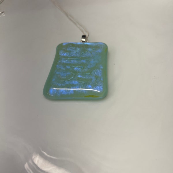 Dichroic fused glass pendant with 20 inch necklace. Robins egg blue base and luminescent blues and purple dichroic overlay.
