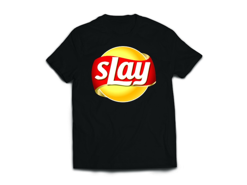 May include: Black t-shirt with a yellow and red logo that says "slay" in a white font.