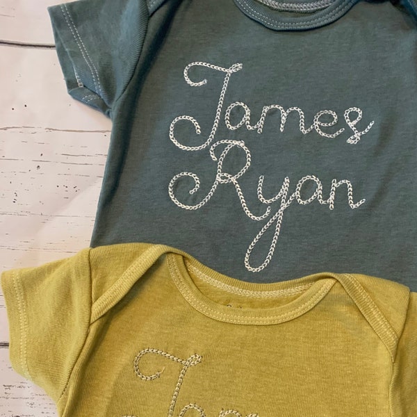 Hand Dyed Mustard Yellow and Dark Sage green embroidered ONESIES® brand bodysuits, personalized big name chain stitch bodysuits, green baby