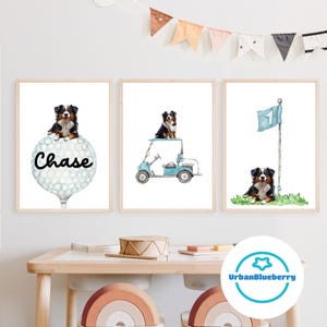 May include: Three framed prints featuring a Bernese Mountain Dog in different golf-themed scenes. The first print shows the dog on top of a golf ball with the name "Chase" written on it. The second print shows the dog riding in a blue golf cart. The third print shows the dog standing next to a golf flag with the number "1" on it.