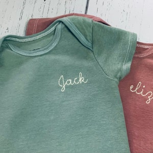 Hand dyed personalized embroidered baby bodysuits in earth tones, dark sage green, cinnamon bodysuits, sage green ONESIES® brand bodysuit