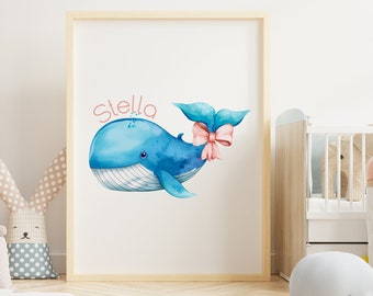 May include: A watercolor illustration of a blue whale with a pink bow on its tail fin. The whale is swimming to the right and the text "Stella" is written above it in pink.